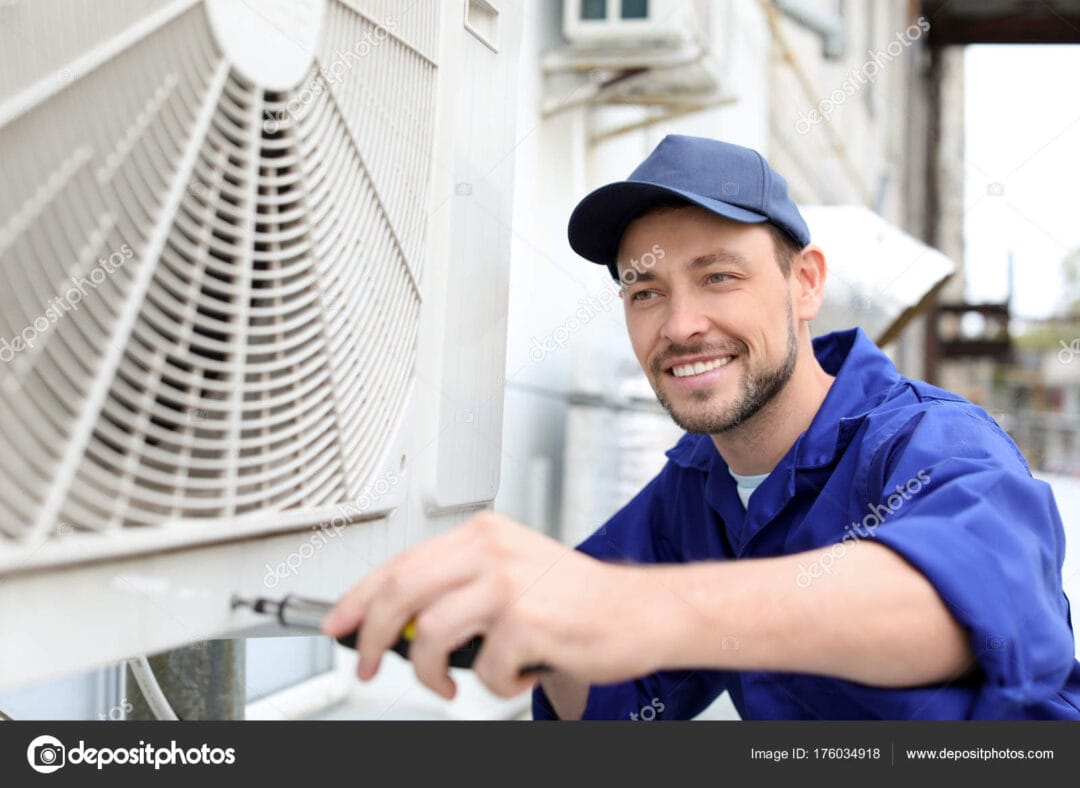 Male Technician Repairing Air Conditioner Outdoors