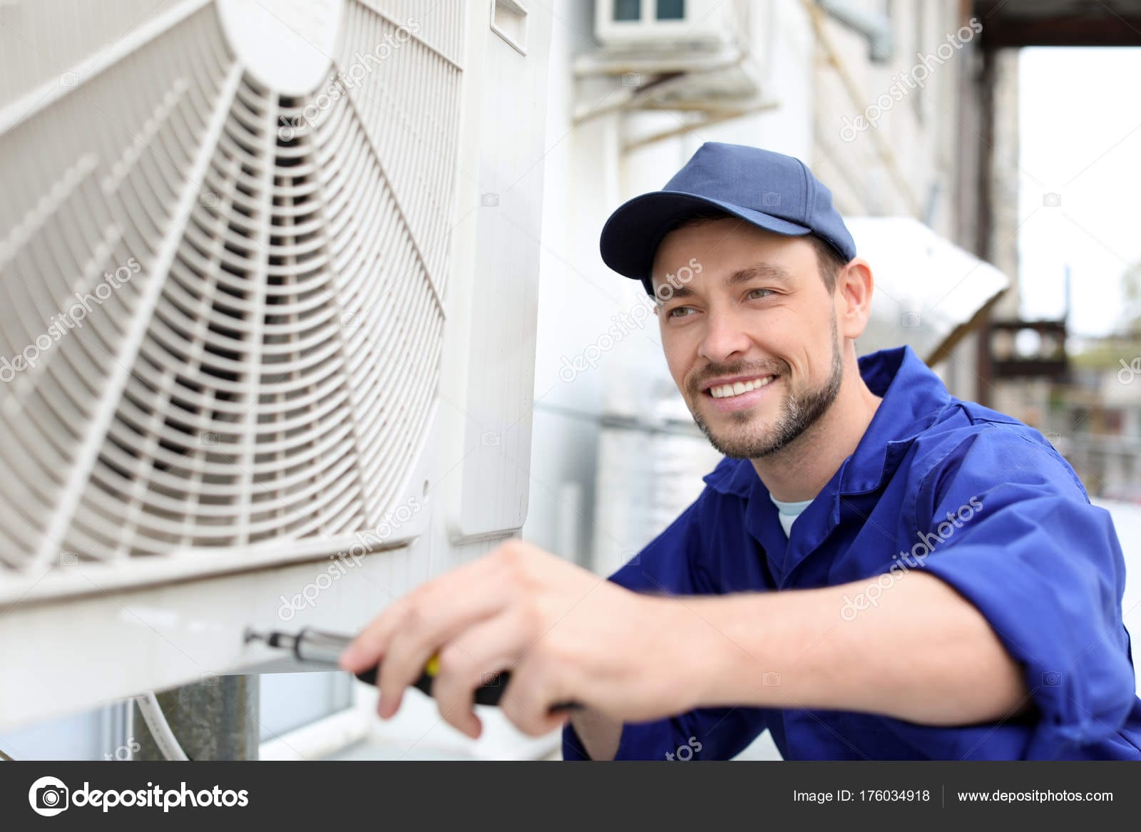 Male Technician Repairing Air Conditioner Outdoors